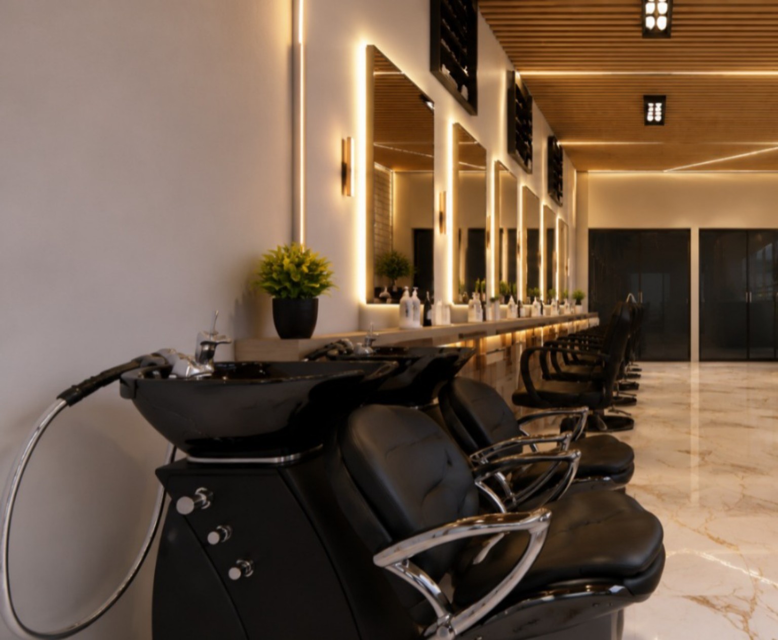 Lavatórios do Vellora Beauty com poltronas pretas e iluminação âmbar